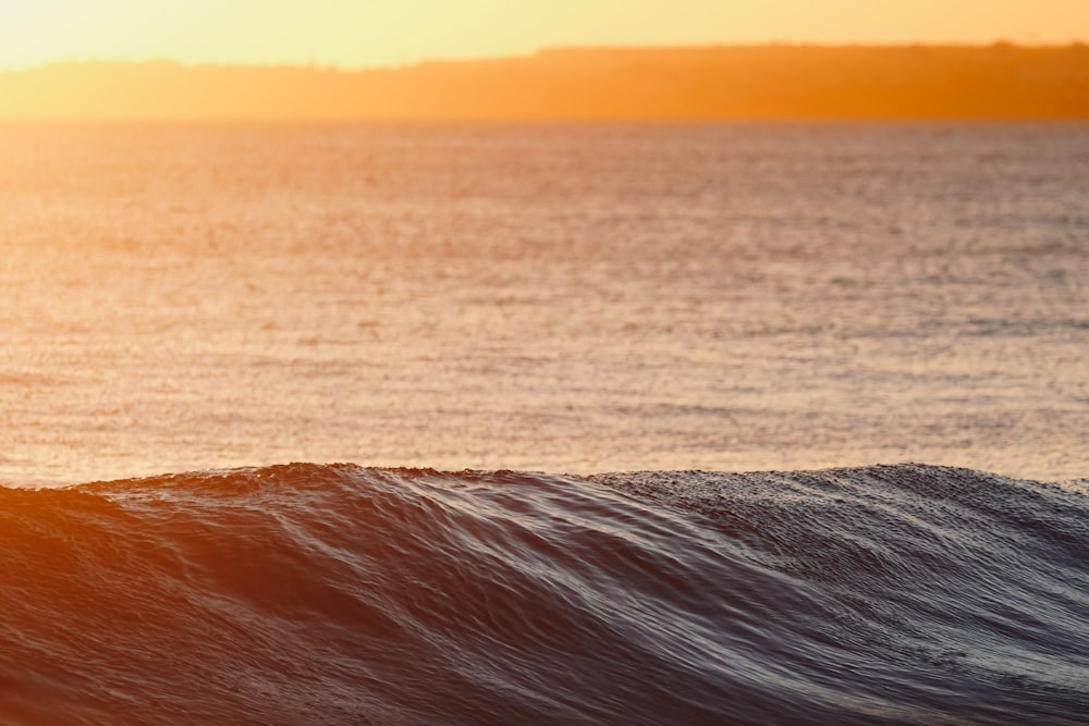 a man riding a wave on top of a surfboard