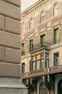A close-up of colonial-era architectural details, featuring arches and wrought iron balconies