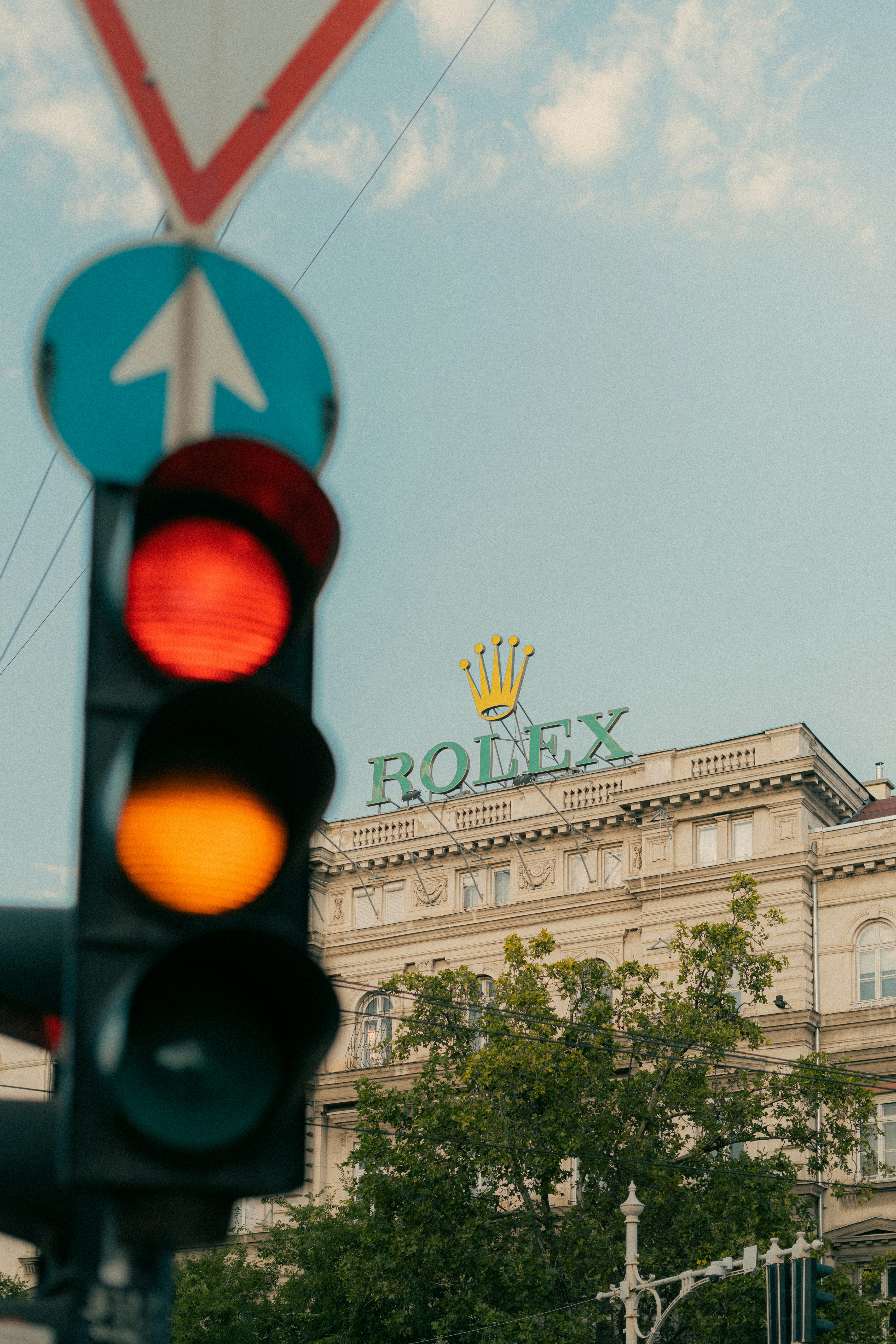 a traffic light with a building in the background