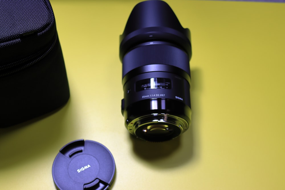 a camera lens sitting on top of a yellow table