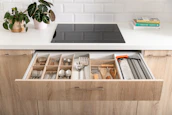 A bright, modern kitchen drawer filled with a full set of colorful Silkaura silicone tools.