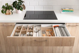 A bright, modern kitchen drawer filled with a full set of colorful Silkaura silicone tools.