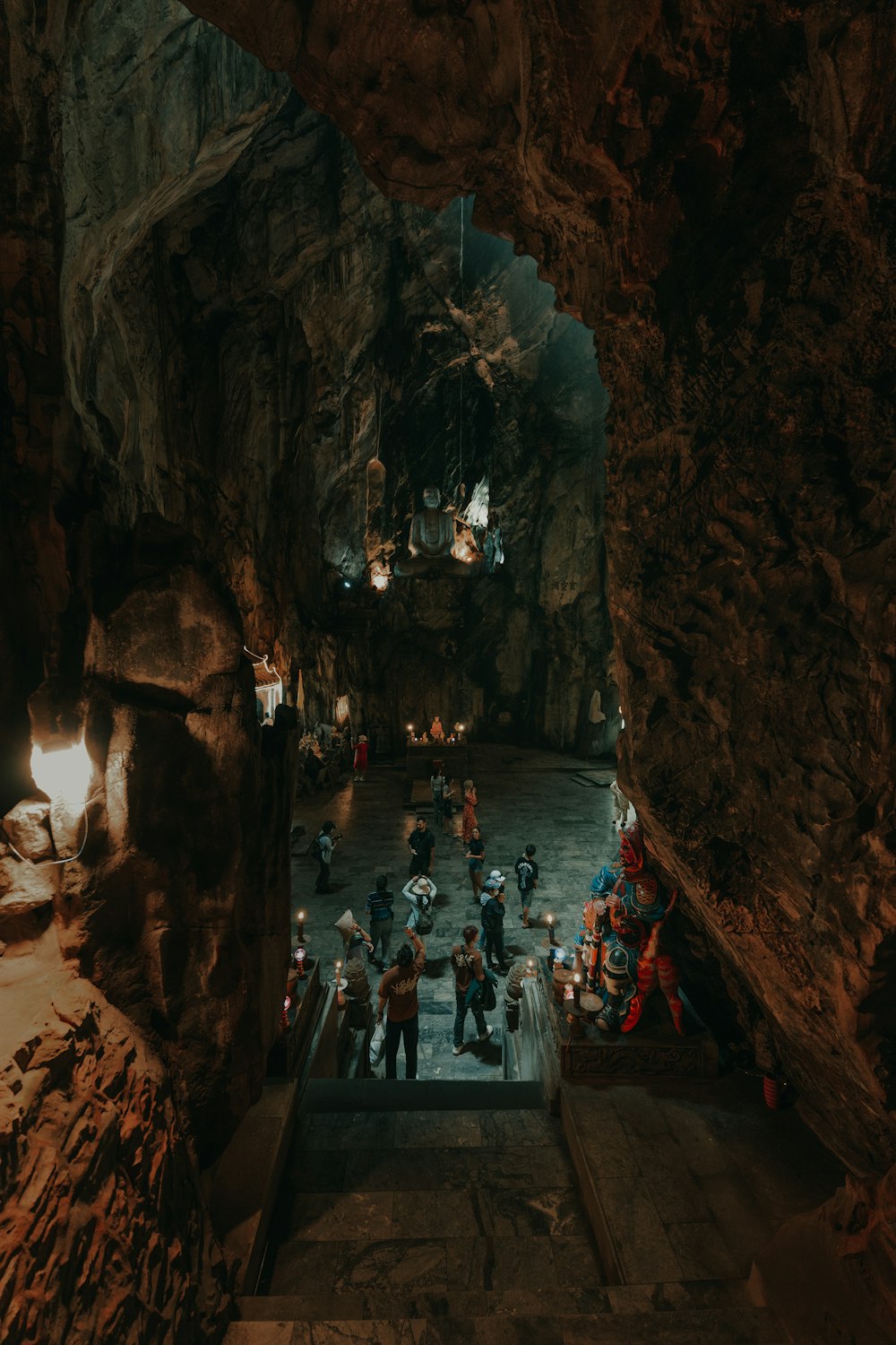 a group of people standing inside of a cave