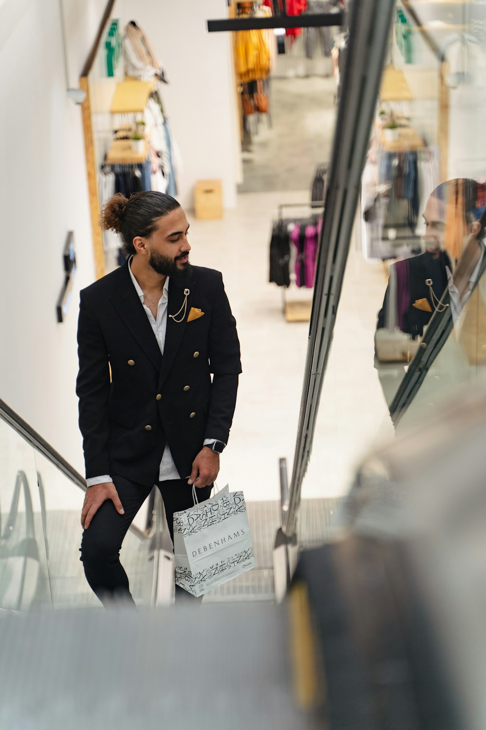 a man in a suit and tie holding a shopping bag