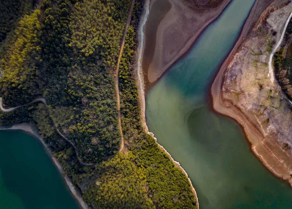 an aerial view of a body of water surrounded by trees