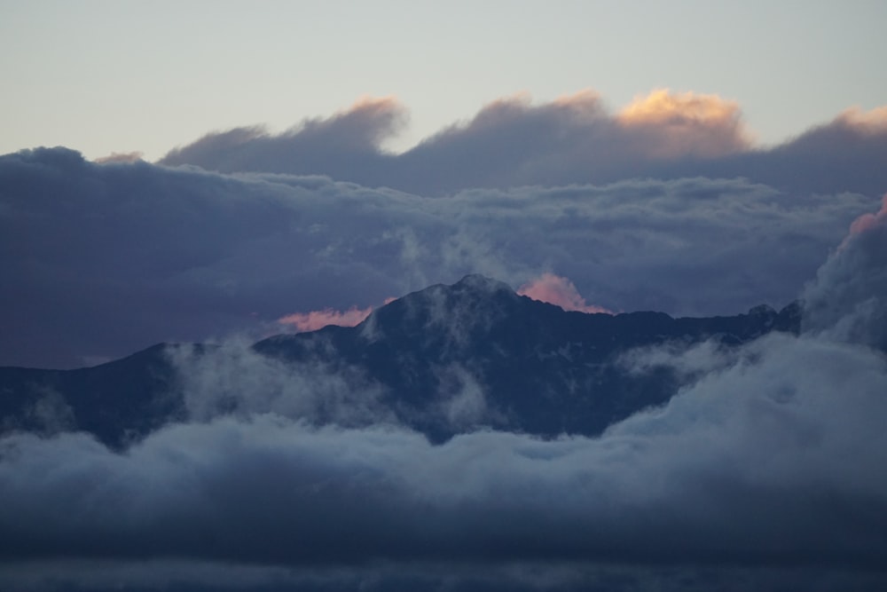 a view of a mountain covered in clouds