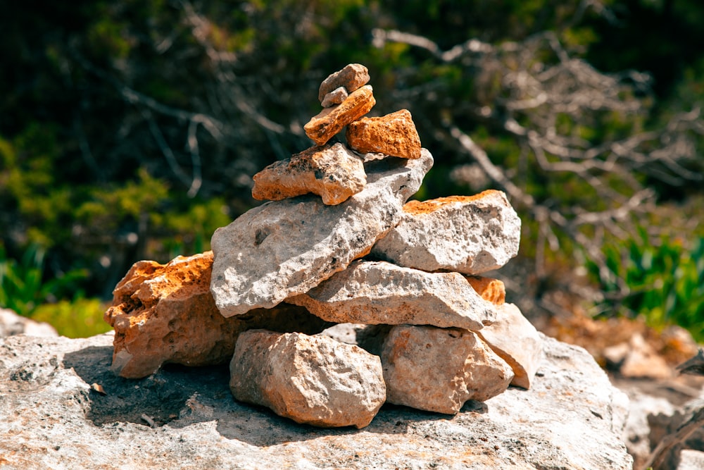 a pile of rocks sitting on top of a rock