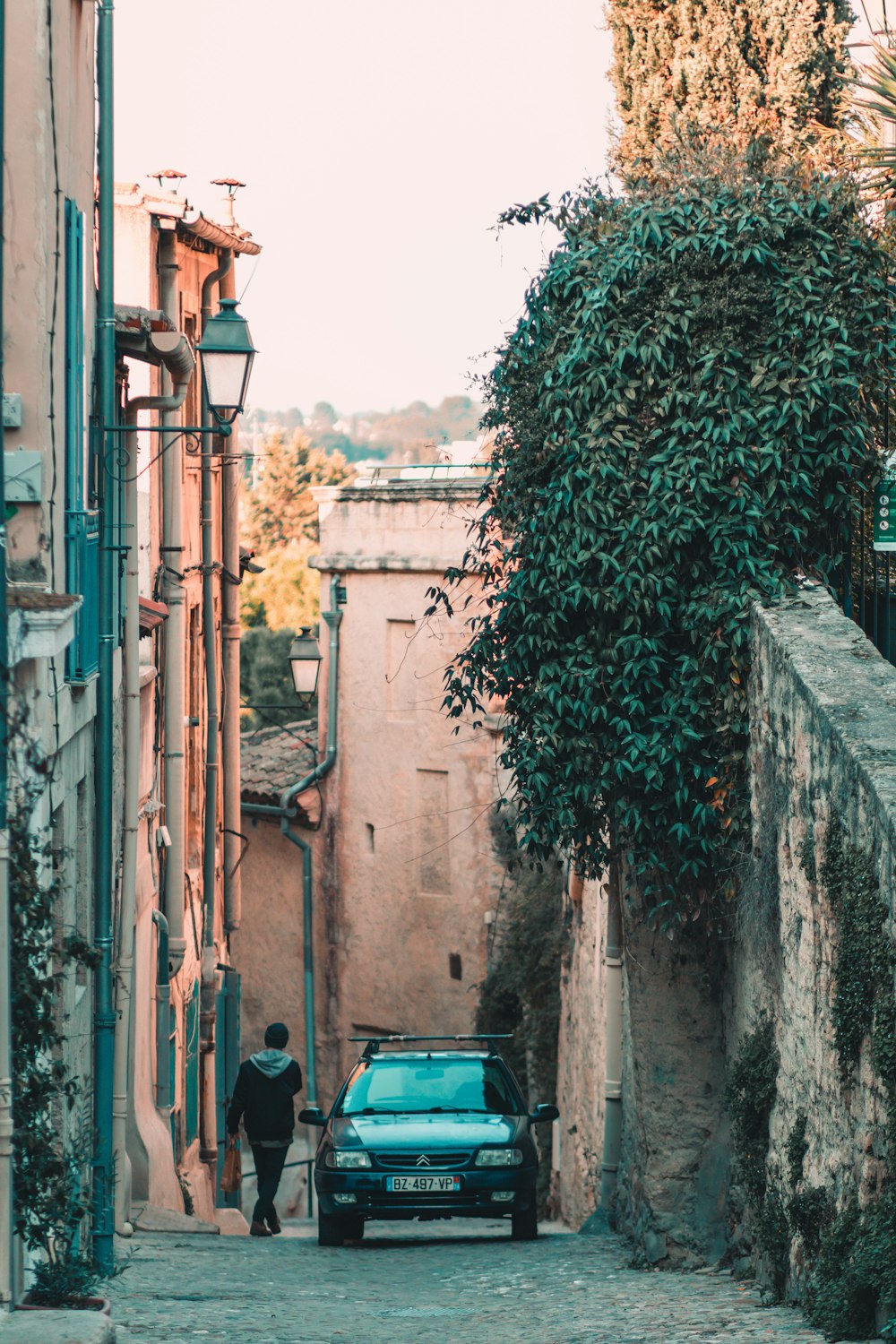 a car parked on the side of a narrow street