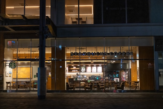 Interior view of a Star Frappe store with comfortable seating, soft lighting, and customers happily sipping milk tea.