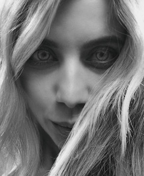 A striking black-and-white portrait of a woman with intense eyes.