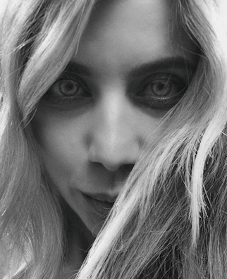 Black and white portrait of an actress with expressive eyes.