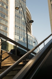 Modern commercial building with reflective glass windows under a clear sky.