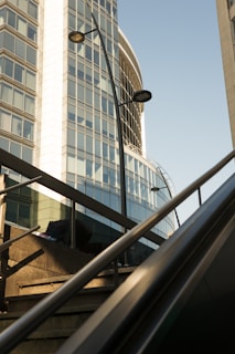 Modern commercial building exterior with glass facade under clear sky