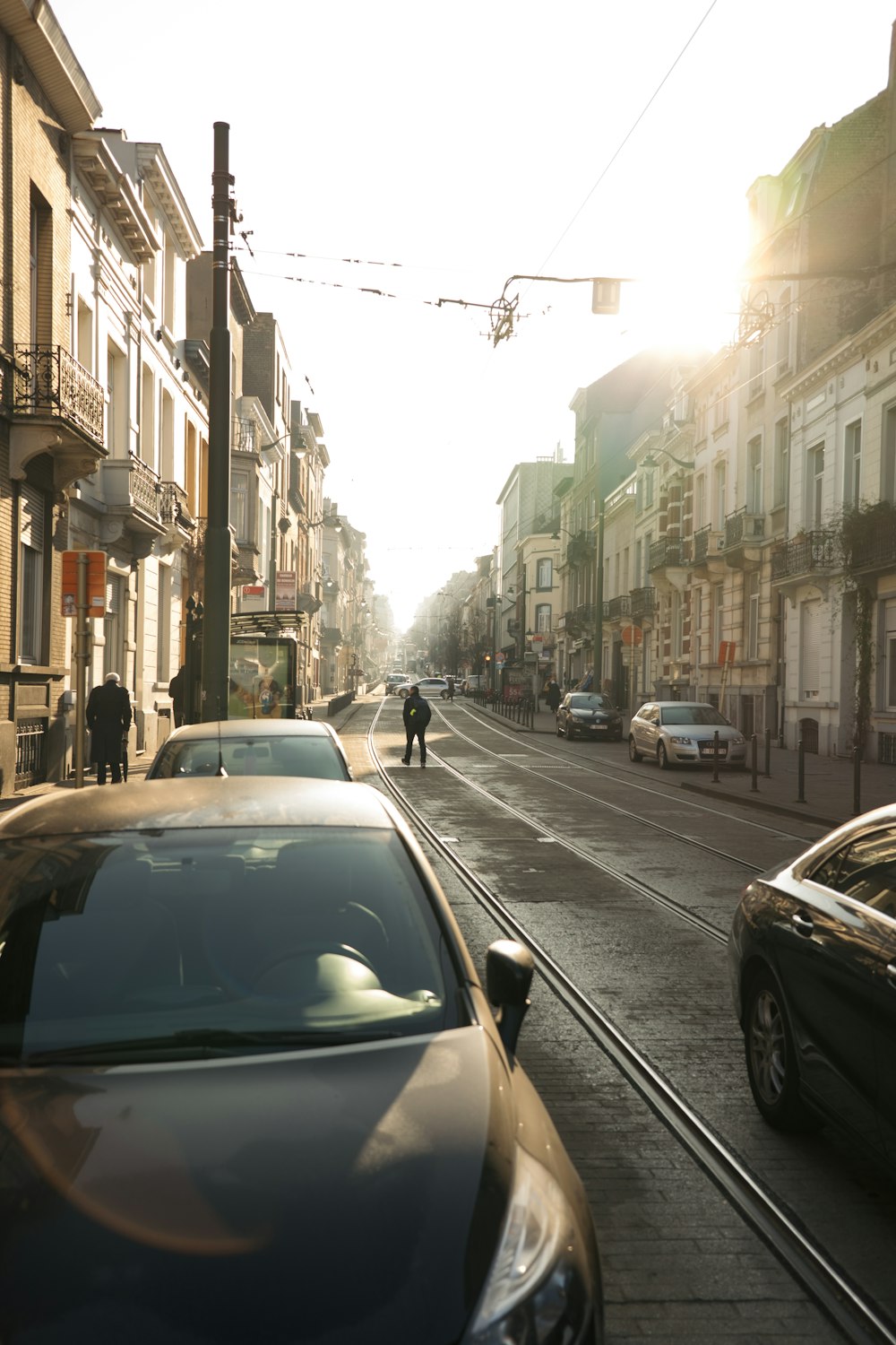 a city street filled with lots of traffic next to tall buildings