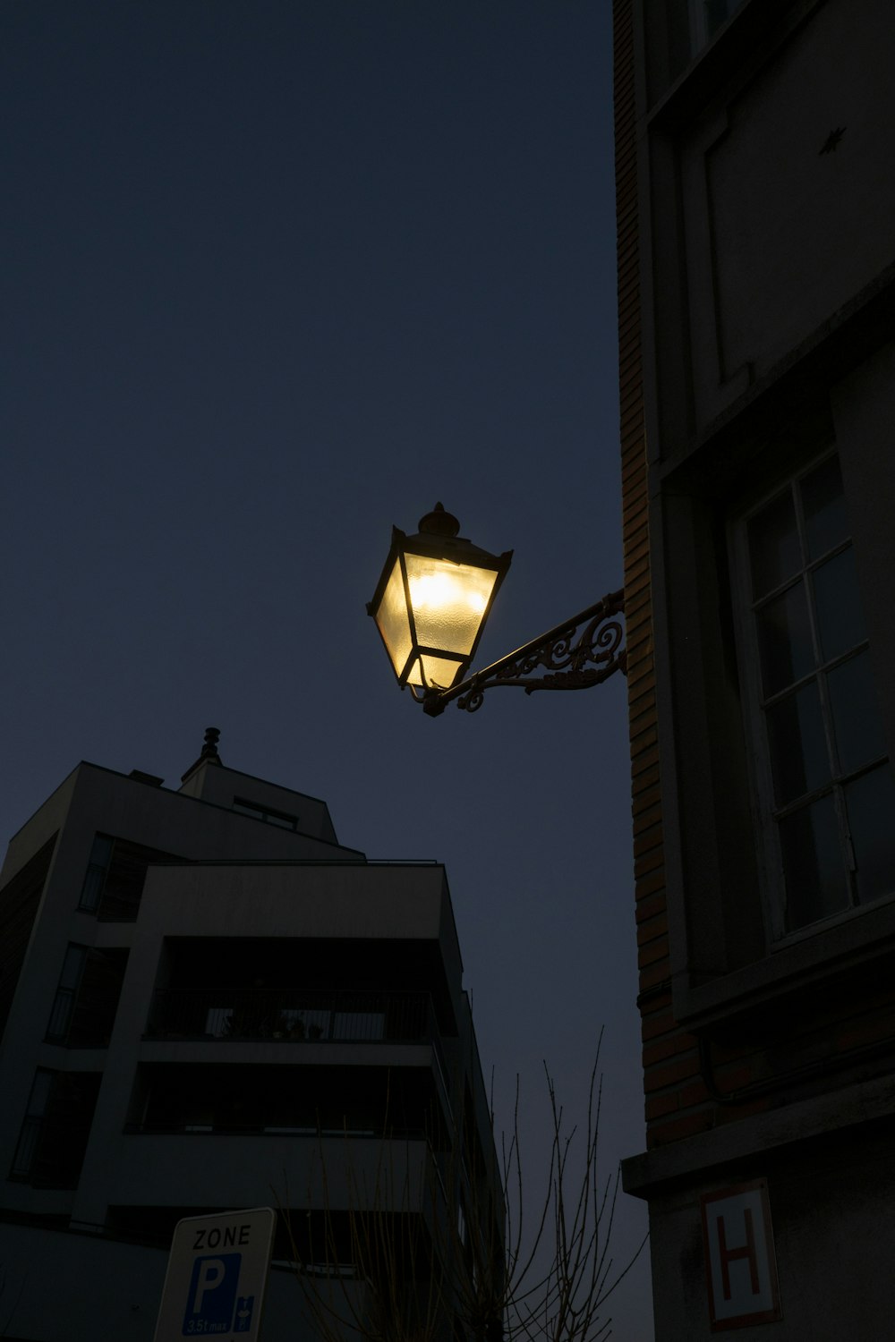 a street light with a building in the background