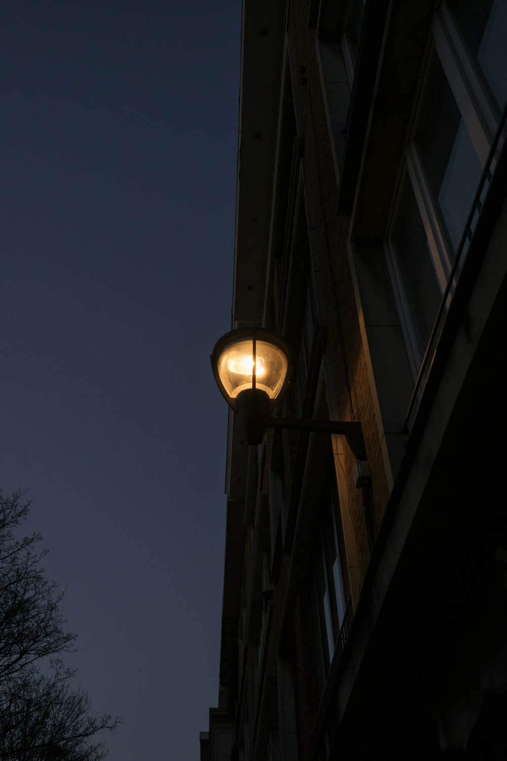 a street light in front of a building at night