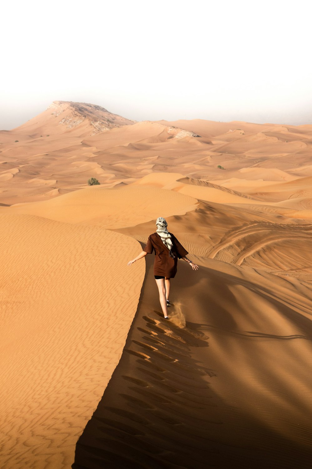 a person walking in the desert with a backpack