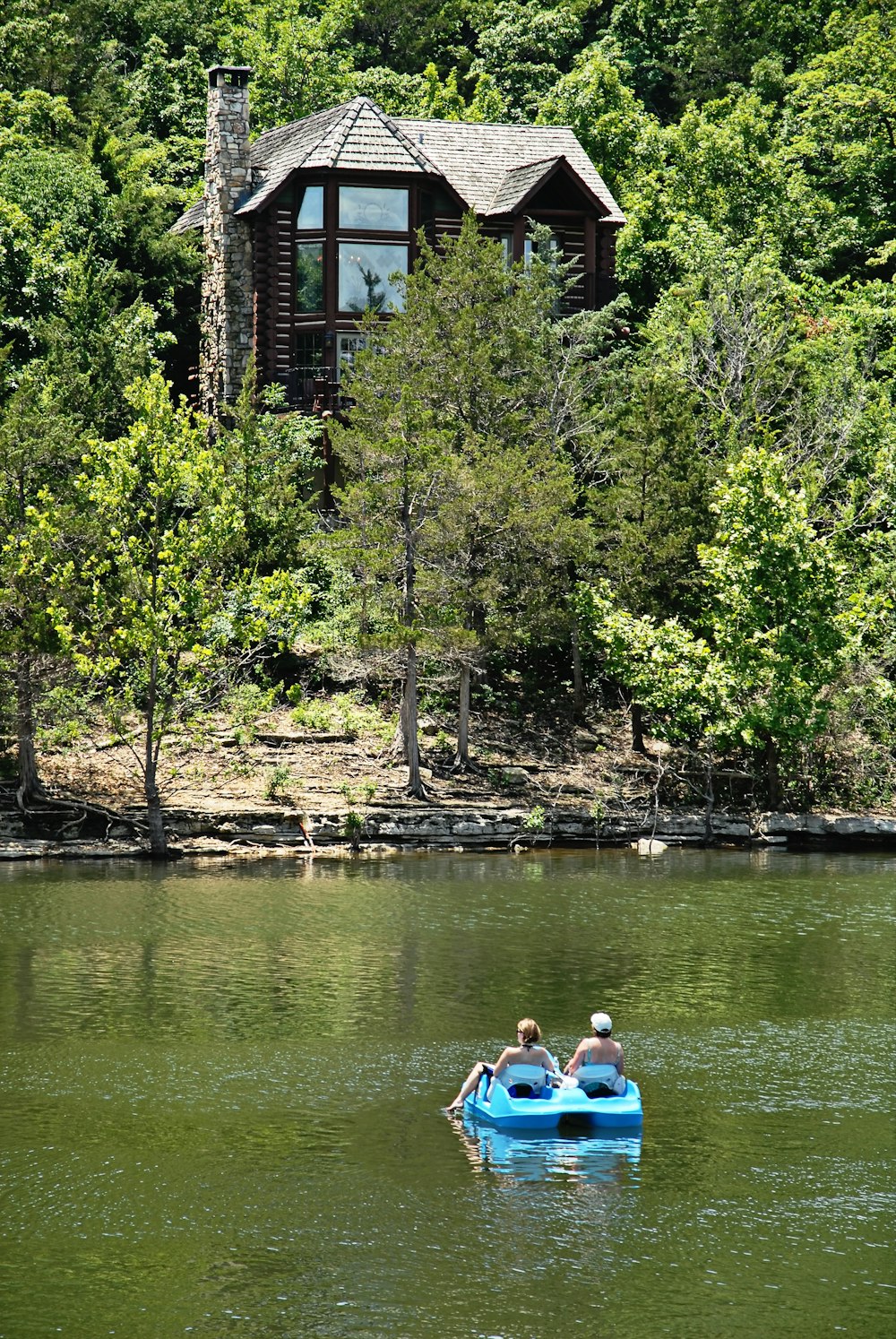 a couple of people in a small boat on a lake