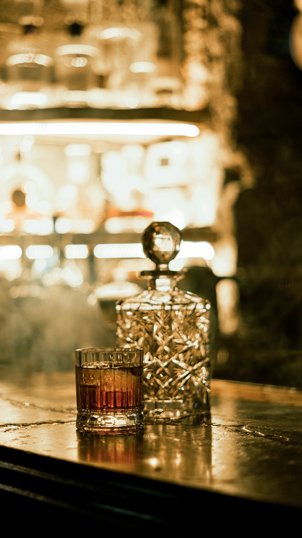 a glass of whiskey sitting on top of a table