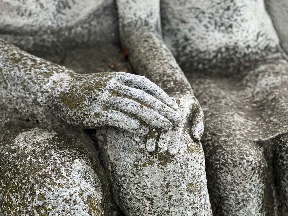 a close up of a statue of a person with their hands on the back of