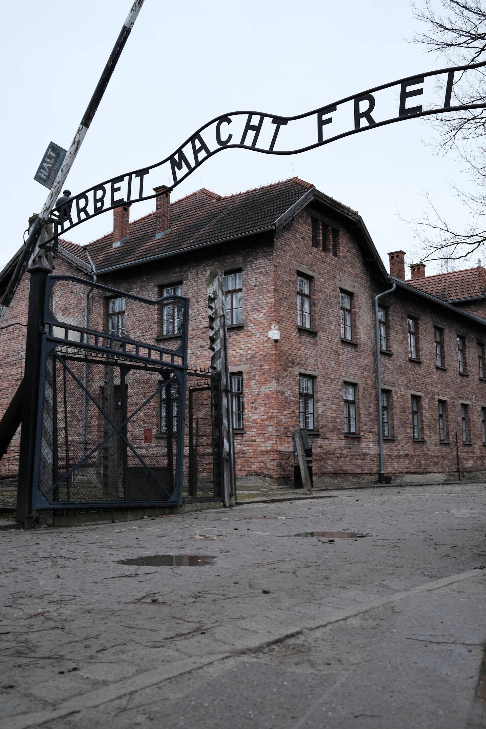 an old brick building with a large iron gate in front of it