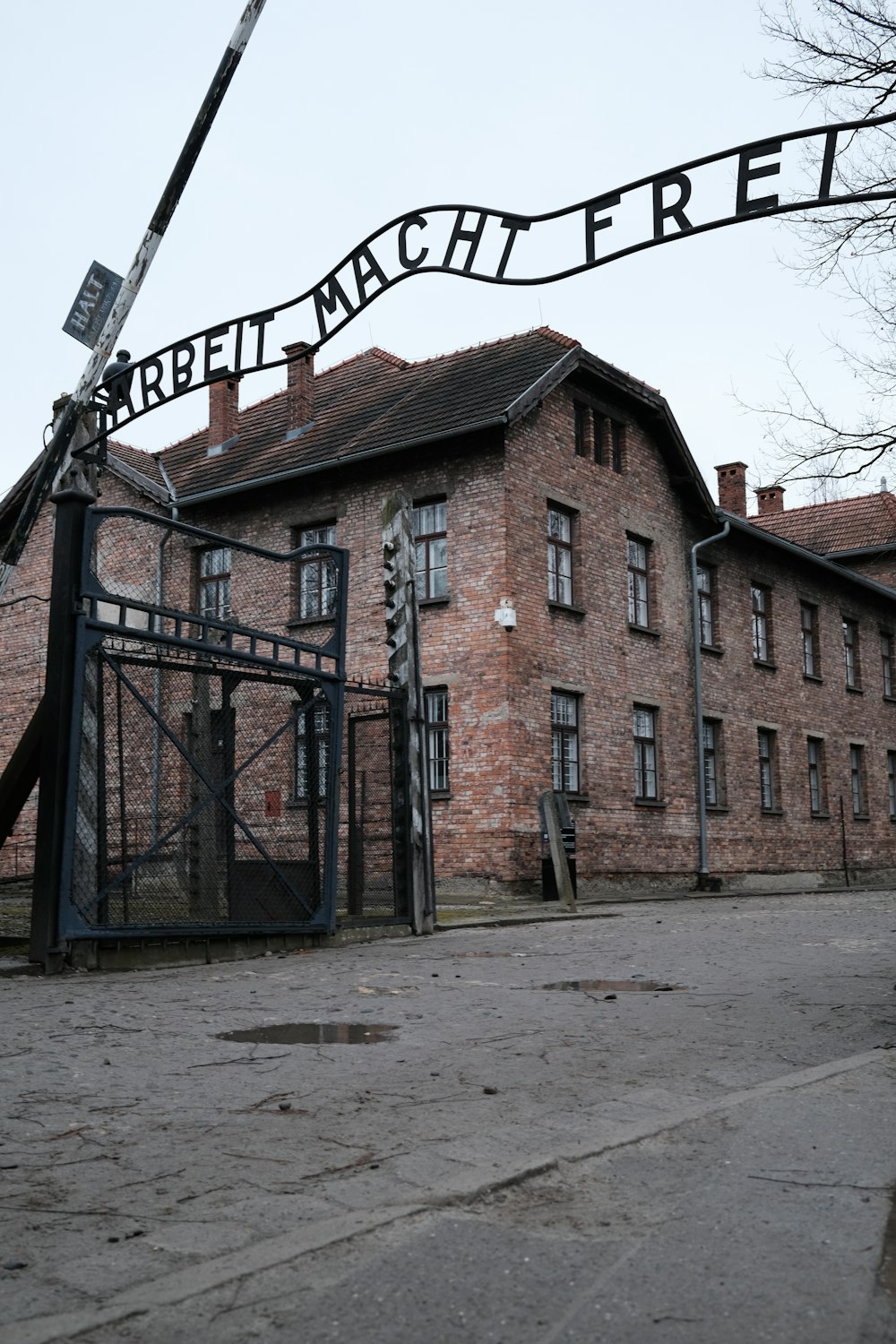 an old brick building with a large iron gate in front of it