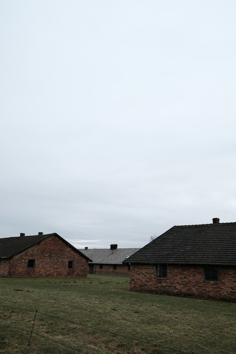 a couple of buildings sitting on top of a lush green field