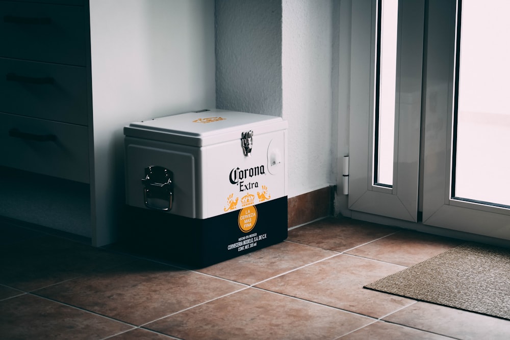 a cooler sitting on the floor next to a window