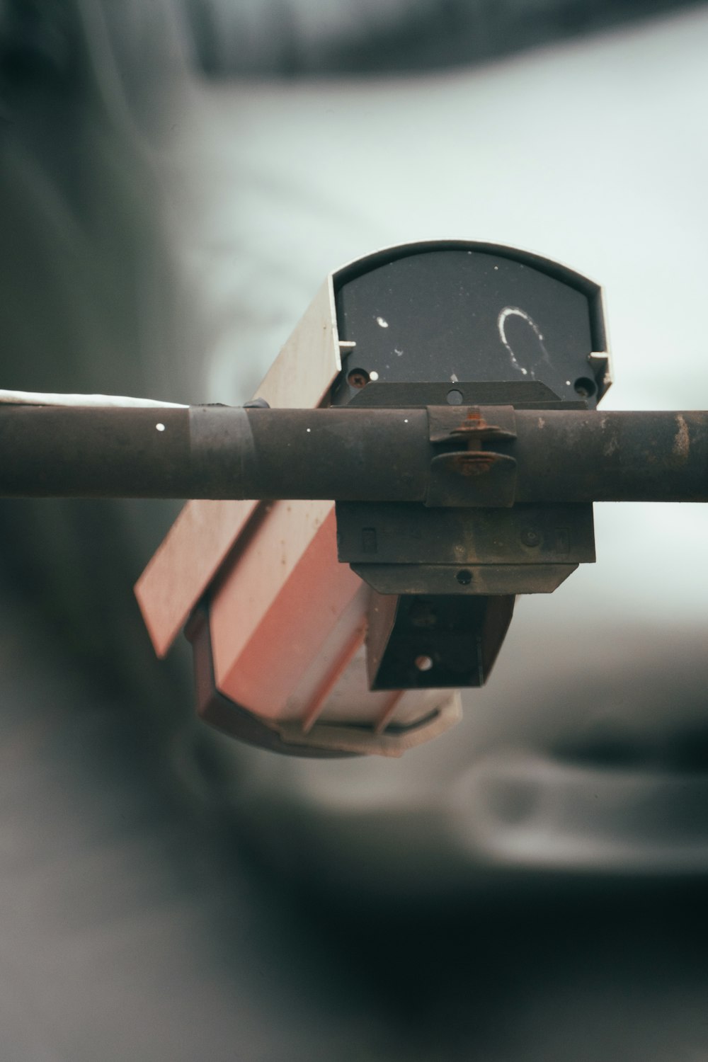 a close up of a parking meter with a car in the background