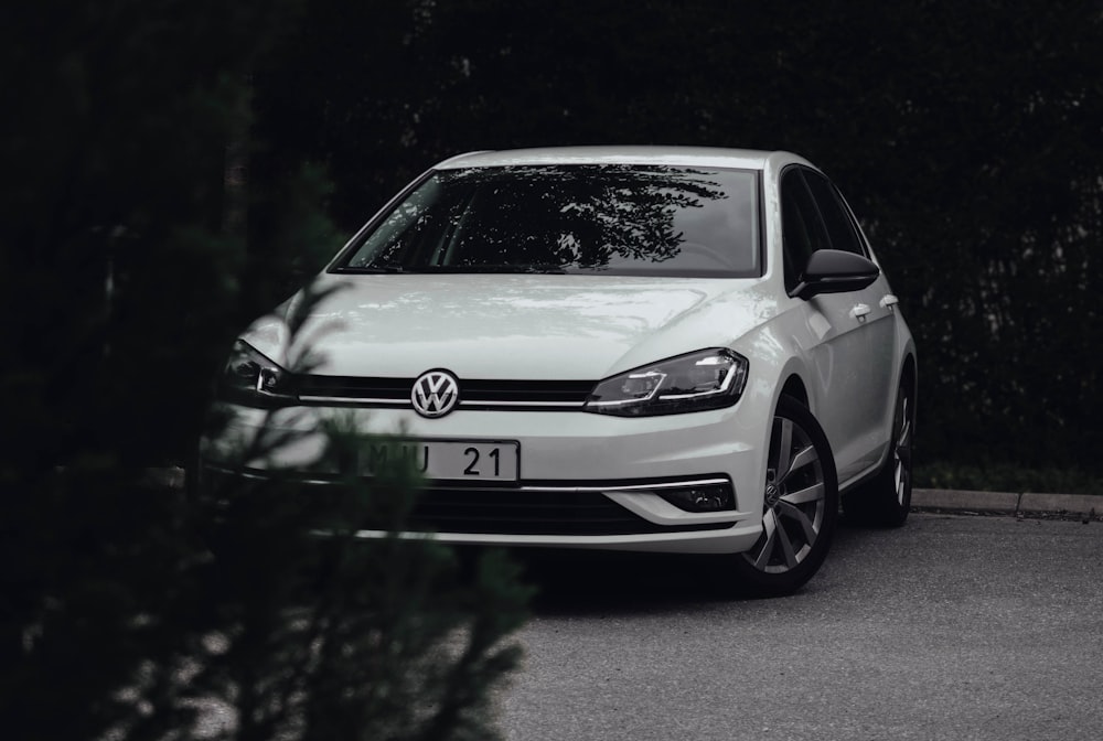 a white car parked on the side of a road