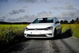 a white car parked on the side of a road