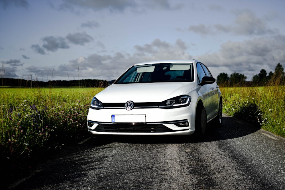 a white car parked on the side of a road