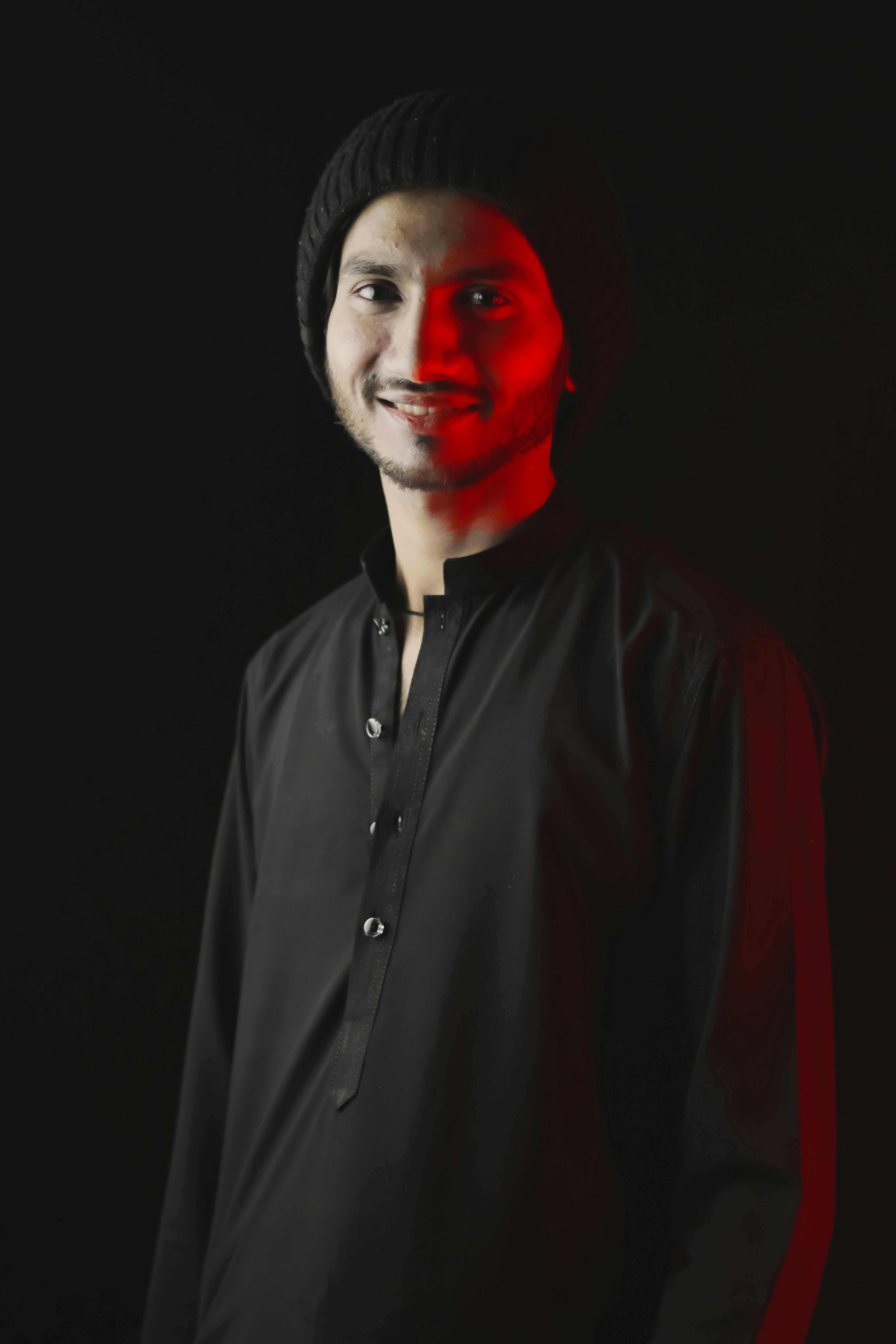 a man in a black shirt with a red light on his face