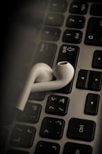 A student listening to Mandarin audio lessons on a laptop.