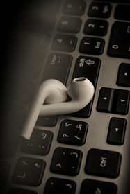 A student listening to Mandarin audio lessons on a laptop.