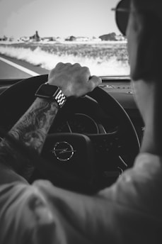 A dynamic image of a person wearing automotive-inspired apparel while driving.