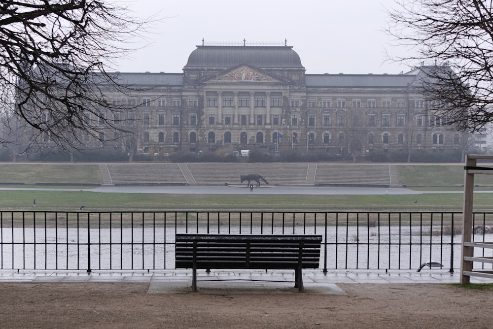 a bench sitting in front of a large building