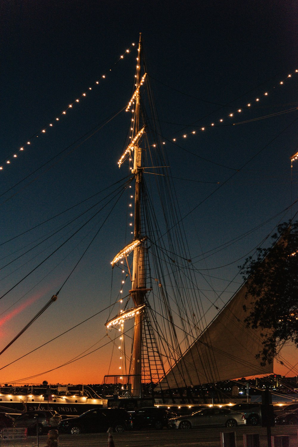 a tall ship is lit up at night