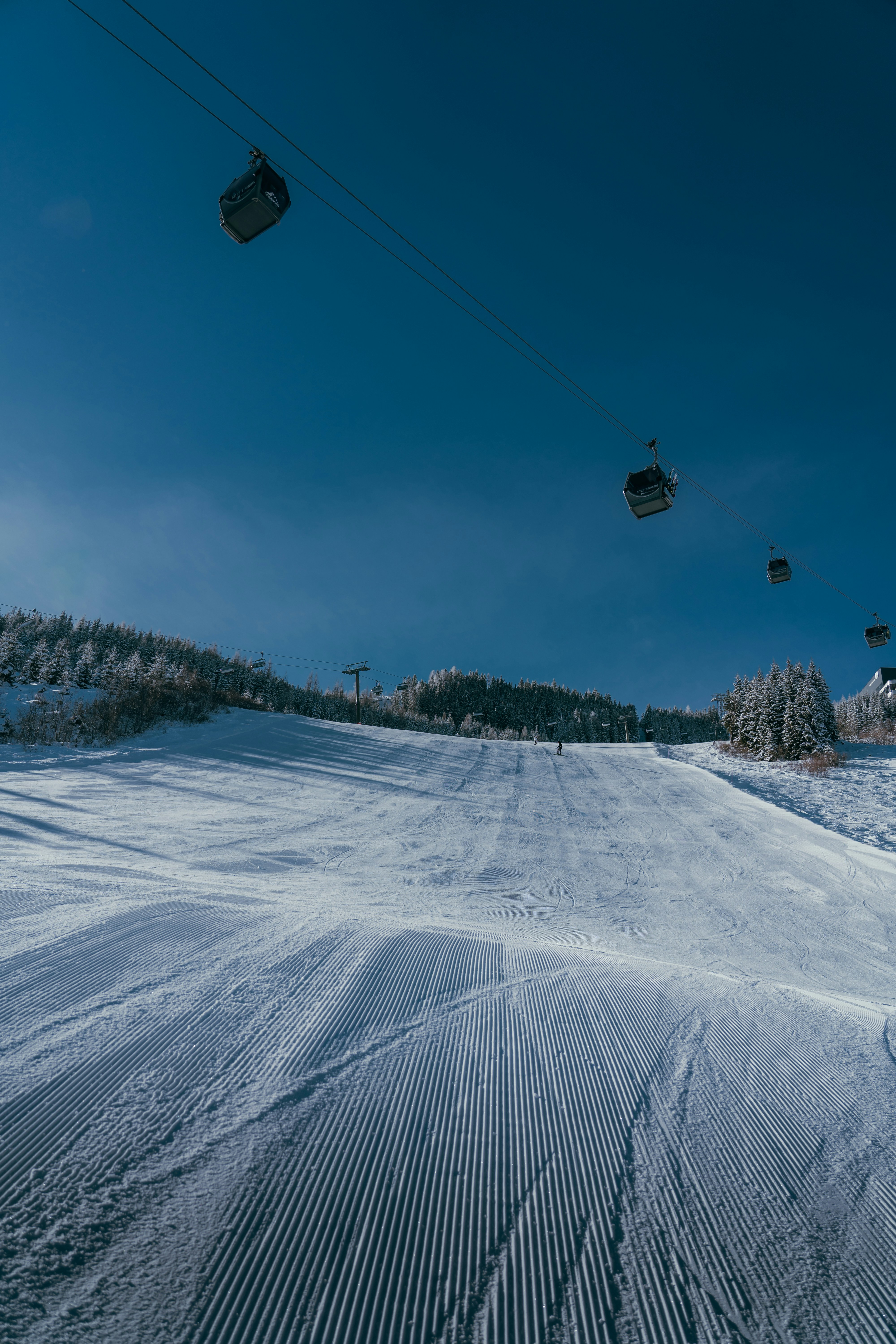 a person riding a snowboard down a snow covered slope