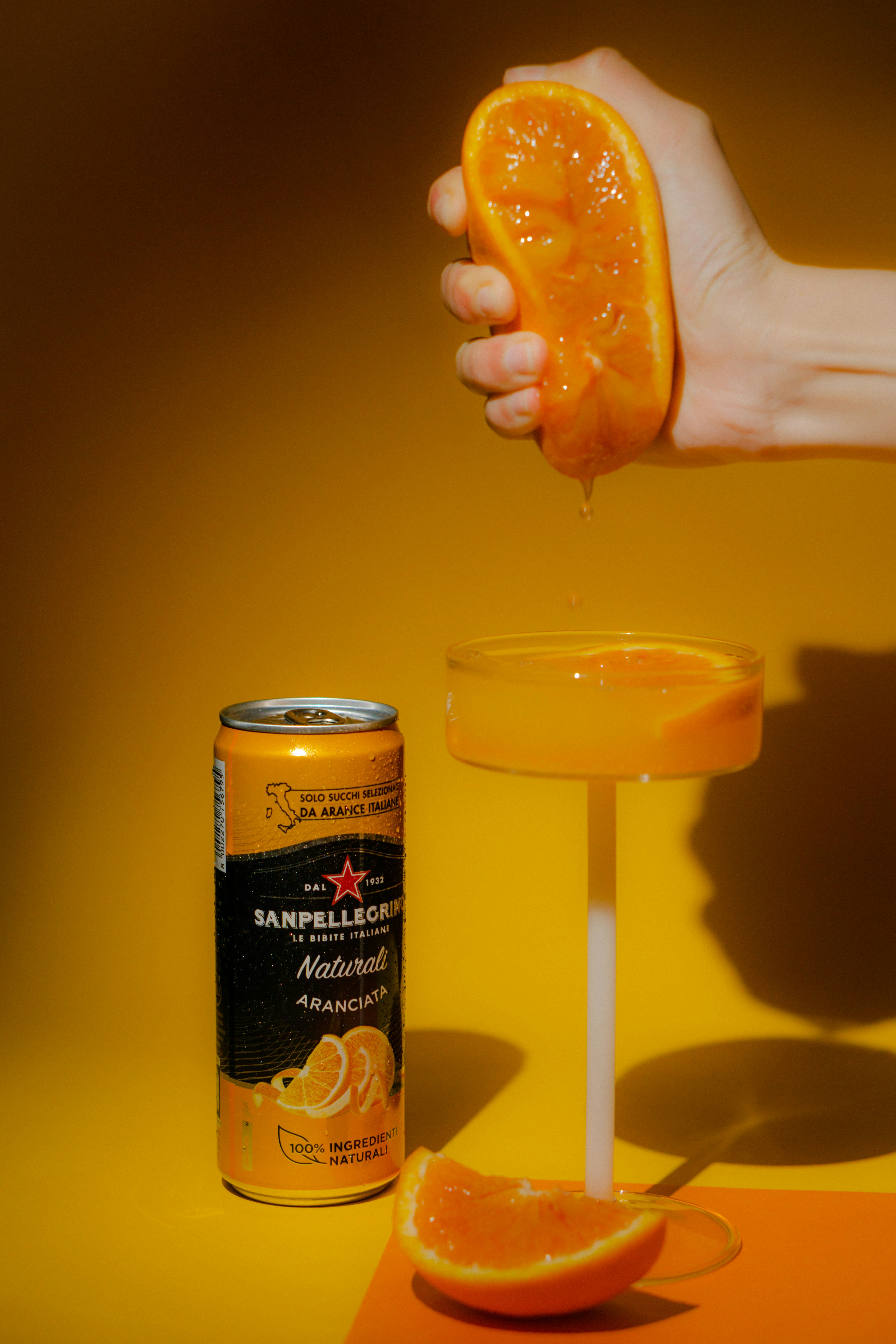 a can of orange juice being poured into a glass