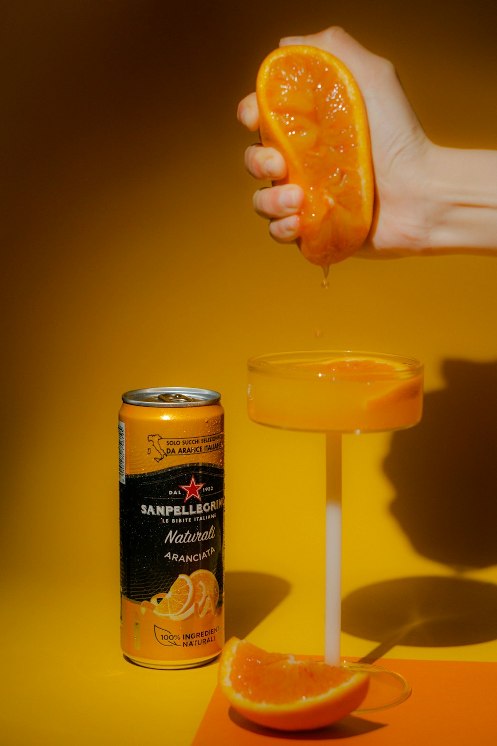 a can of orange juice being poured into a glass