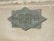 A textured metal plaque mounted on a stone surface, with the words 'Member Federal Reserve System' engraved in a diamond shape.