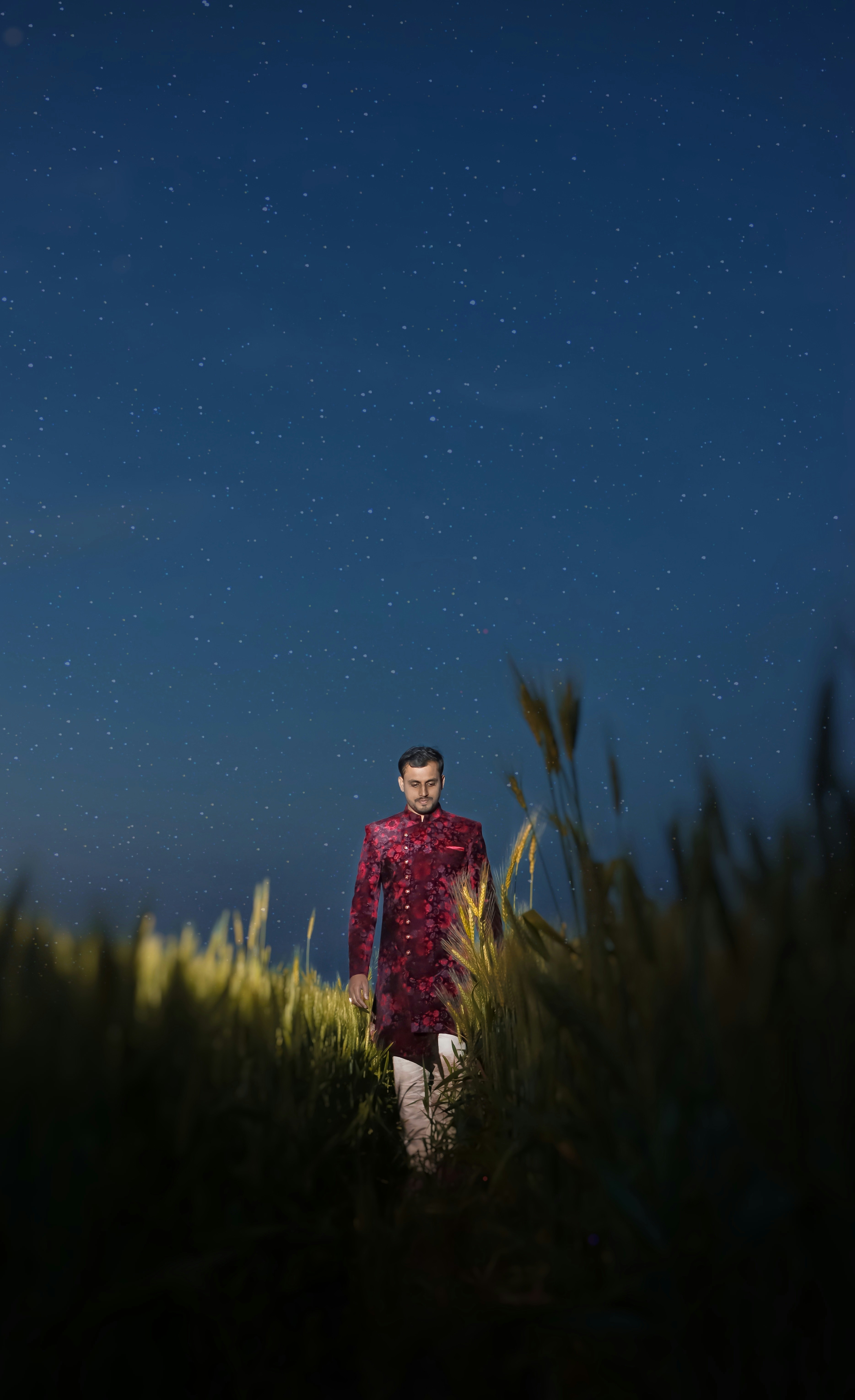 A man in a red shirt is standing in a field photo – Free Background ...