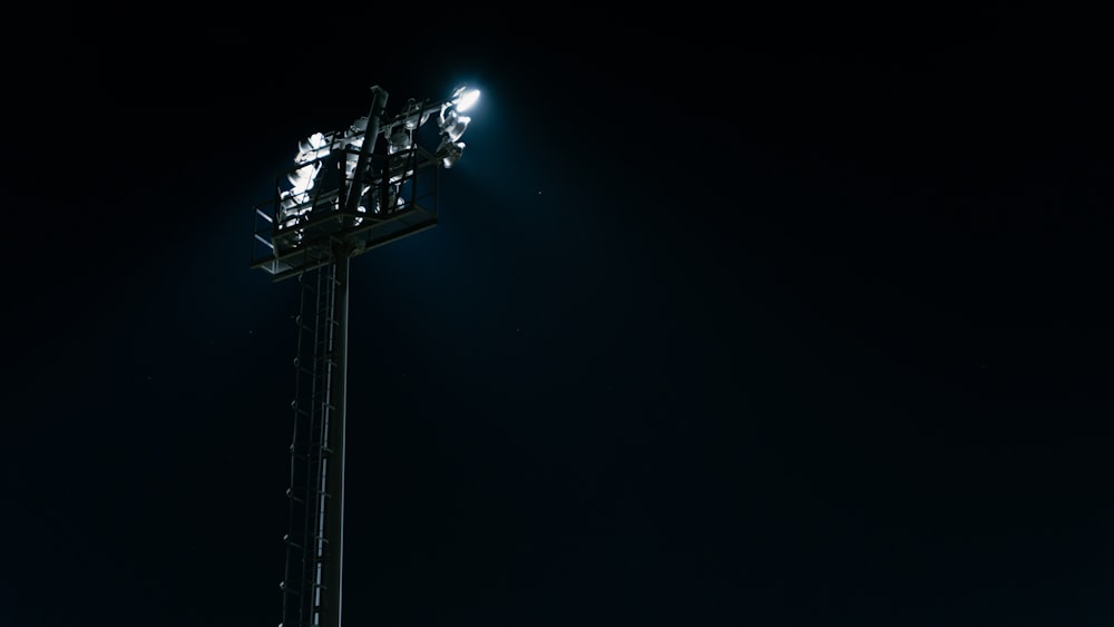 a tall metal pole with a bunch of lights on top of it