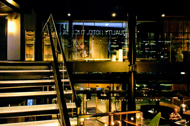 Illuminated staircase leading to a hotel entrance at night