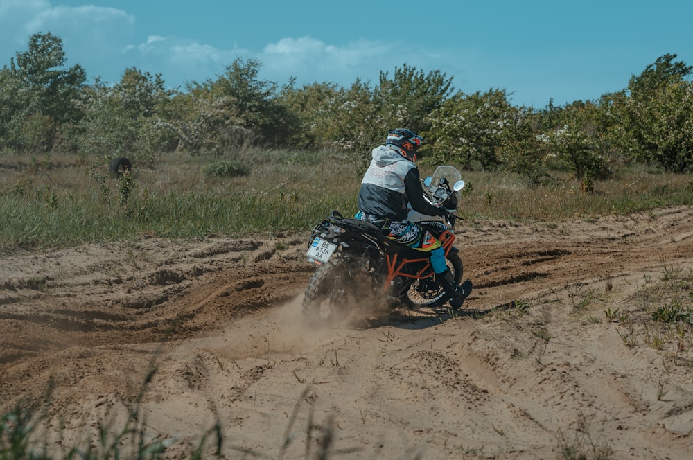 a person riding a dirt bike on a dirt road