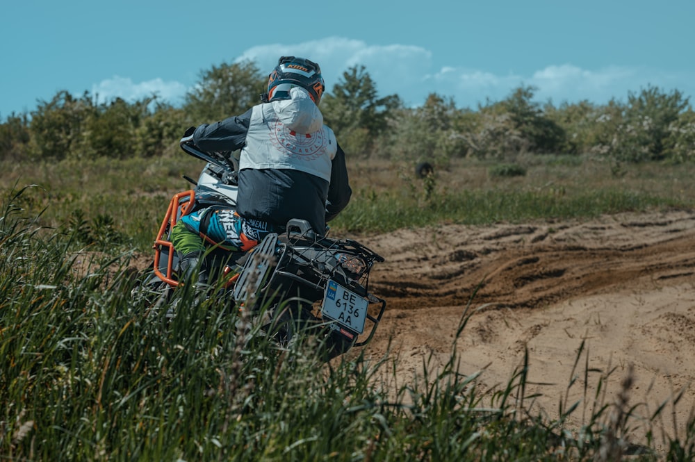 a person riding a dirt bike on a dirt road