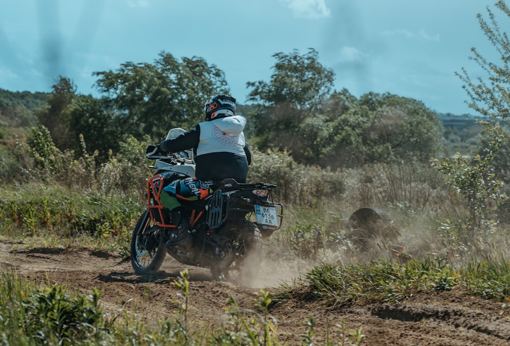 a man riding a dirt bike on a dirt road