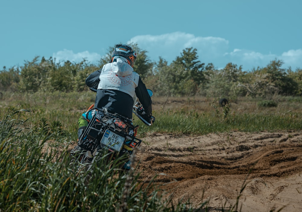 a person riding a dirt bike on a dirt road