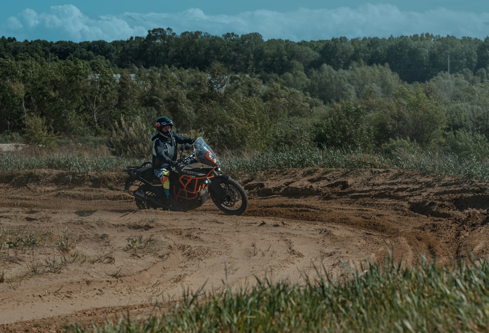 a person riding a motorcycle on a dirt road